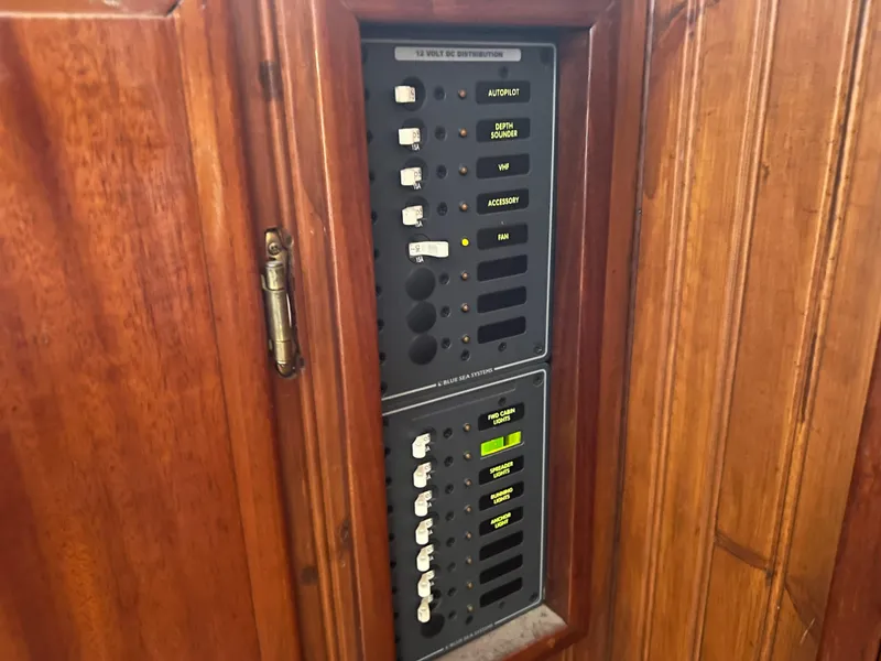 Slide: The Image of Electrical panel inside a 1965 Romsdal Fjord boat with wooden cabinet. - 12