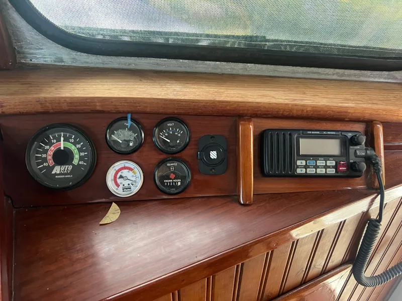 Slide: The Image of 1965 Romsdal Fjord boat dashboard with gauges and radio equipment. - 13
