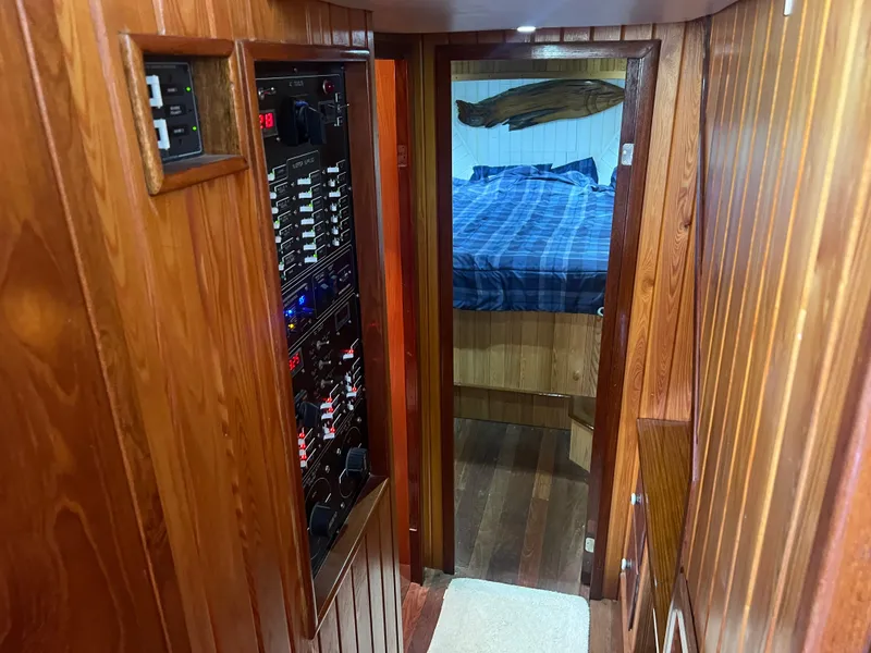 Slide: The Image of Wood-paneled cabin interior of 1965 Romsdal Fjord boat, featuring control panels and a cozy sleeping area. - 14