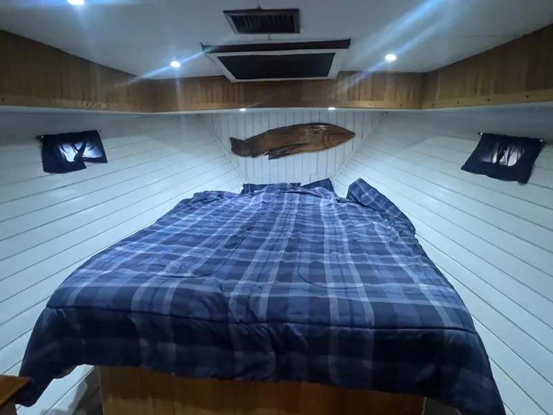 Slide: The Image of Cozy cabin interior of 1965 Romsdal Fjord boat with plaid bedding and wooden accents. - 15