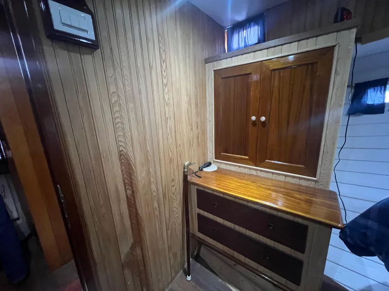 Slide: The Image of Wood-paneled interior of a 1965 Romsdal Fjord boat with cabinets and drawers. - 16