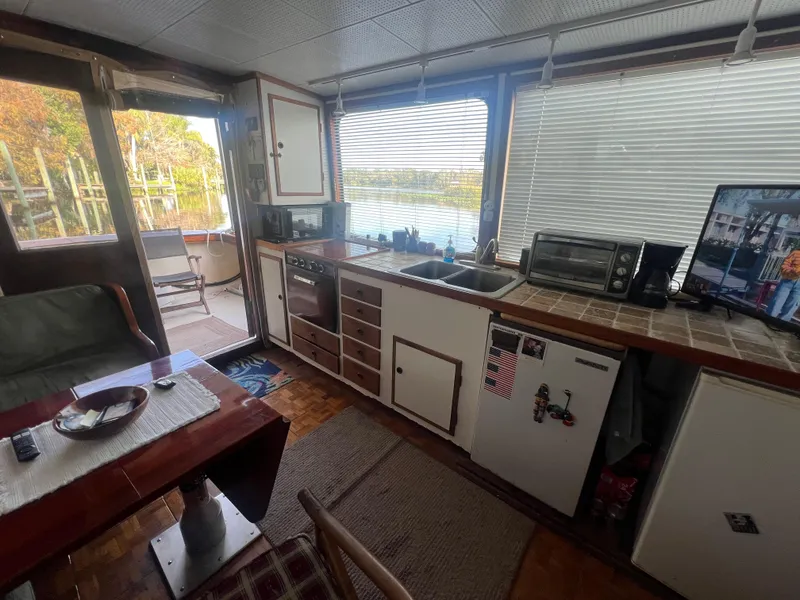 Slide: The Image of Interior of a 1965 Romsdal Fjord boat with kitchen and dining area. - 17