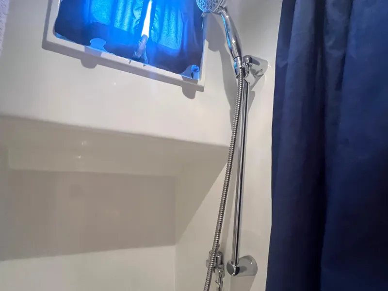 Slide: The Image of Shower area in a 1965 Romsdal Fjord boat with blue curtain and window. - 19