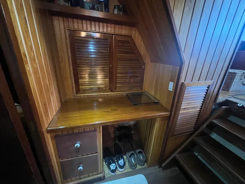 Slide: The Image of Wooden interior of a 1965 Romsdal Fjord boat with storage and shoes. - 21