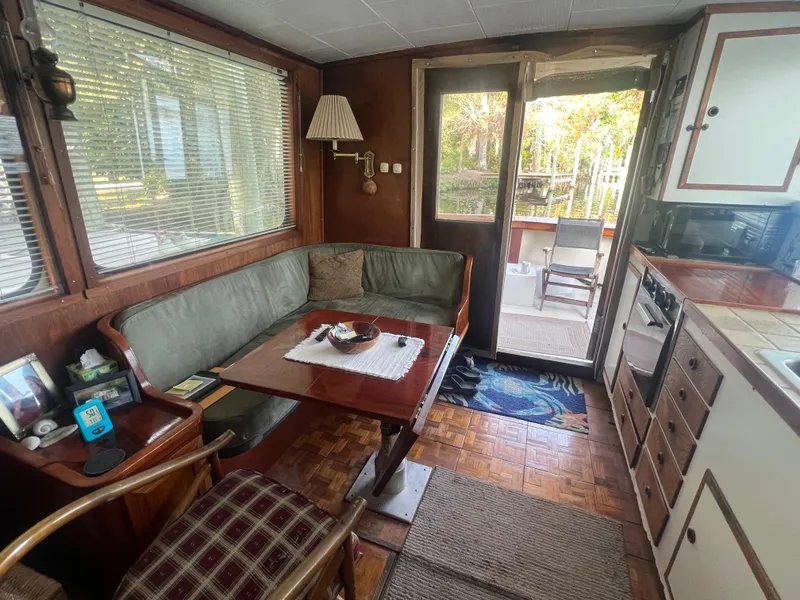 Slide: The Image of Cozy 1965 Romsdal Fjord boat interior with dining area and kitchenette. - 25
