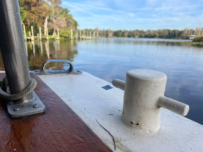 Slide: The Image of 1965 Romsdal Fjord boat on serene lake with lush tree-lined shore. - 26
