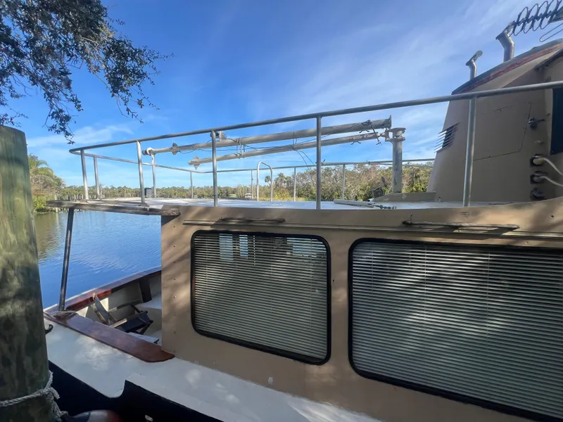 Slide: The Image of 1965 Romsdal Fjord boat docked by a serene lake under a clear blue sky. - 3