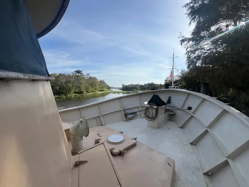 Slide: The Image of 1965 Romsdal Fjord boat deck with scenic river view and clear sky. - 4