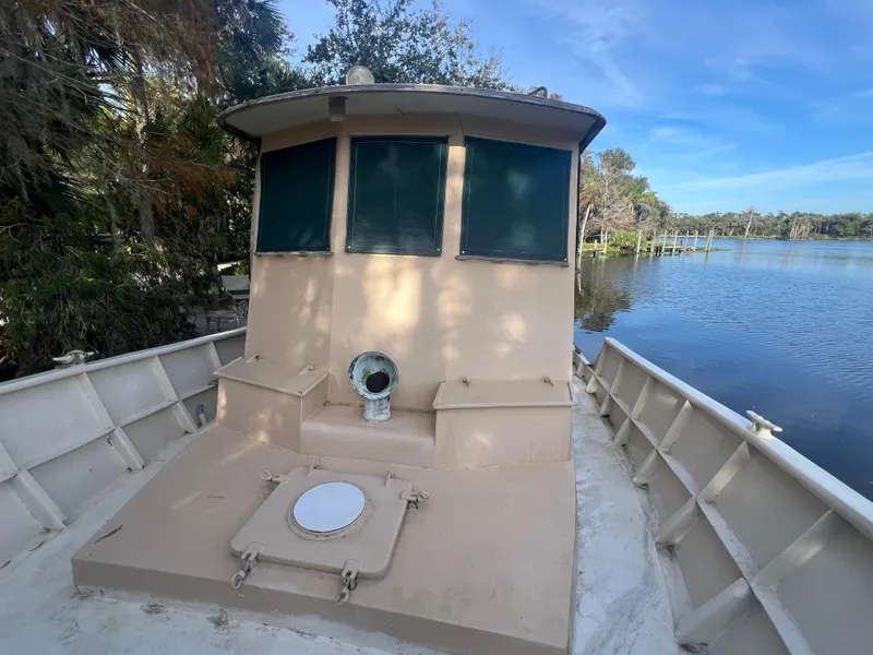 Slide: The Image of 1965 Romsdal Fjord boat on a serene lake with trees in the background. - 5