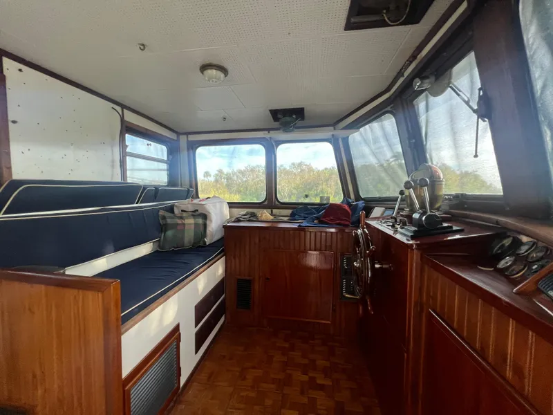 Slide: The Image of Interior of a 1965 Romsdal Fjord boat with wooden paneling and blue seating. - 7