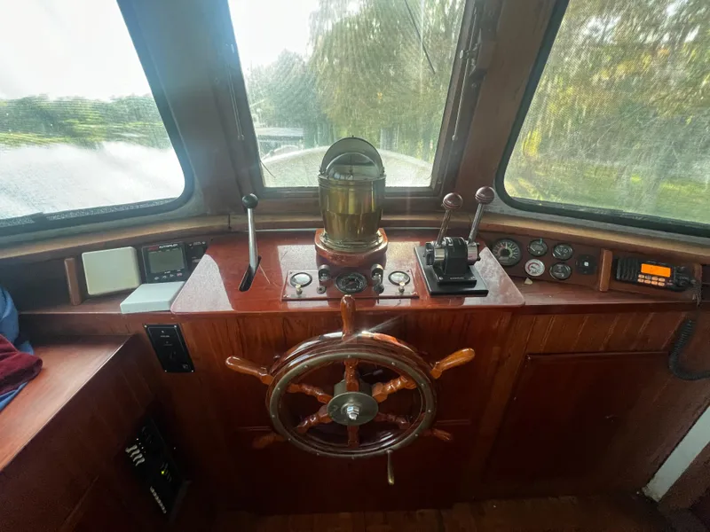 Slide: The Image of Interior of a 1965 Romsdal Fjord boat with wooden steering wheel and navigation instruments. - 8