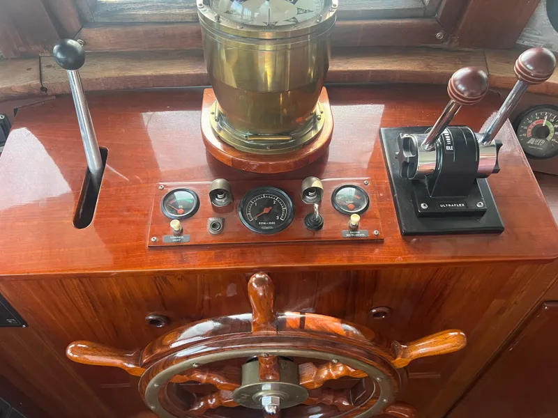 Slide: The Image of Wooden ship helm with brass compass, vintage controls, and levers, Romsdal Fjord 1965 model. - 9