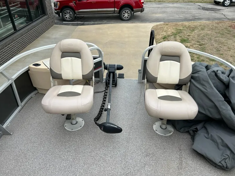 Slide: The Image of 2015 Sun Tracker fb22X3 boat interior with two beige seats and a trolling motor. - 10