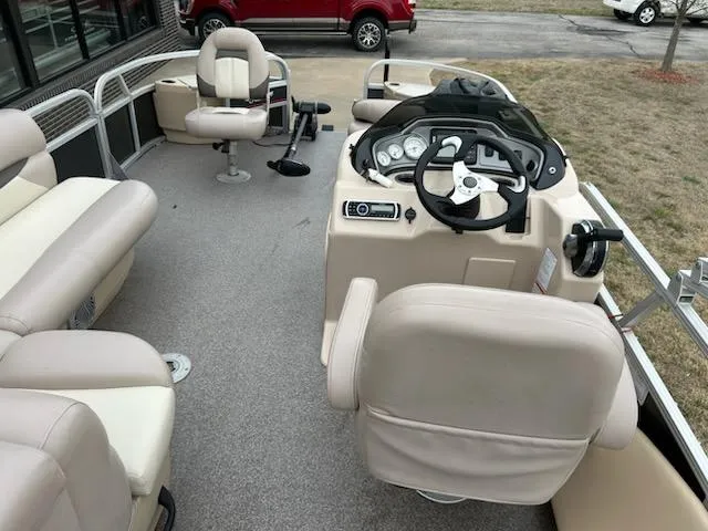 Slide: The Image of Interior of a 2015 Sun Tracker fb22X3 pontoon boat with beige seating and steering console. - 5