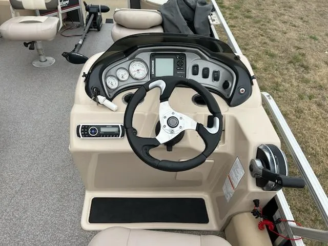 Slide: The Image of 2015 Sun Tracker fb22X3 boat dashboard with steering wheel and control panel. - 6