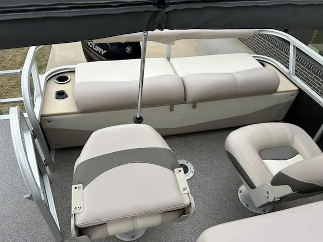 Slide: The Image of 2015 Sun Tracker fb22X3 pontoon boat interior with beige seating and cup holders. - 8