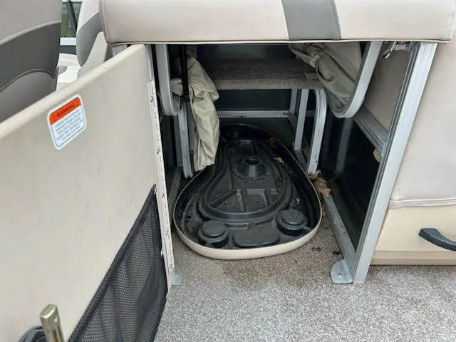 Slide: The Image of Storage compartment in a 2015 Sun Tracker fb22X3 boat, showing interior space and equipment. - 9