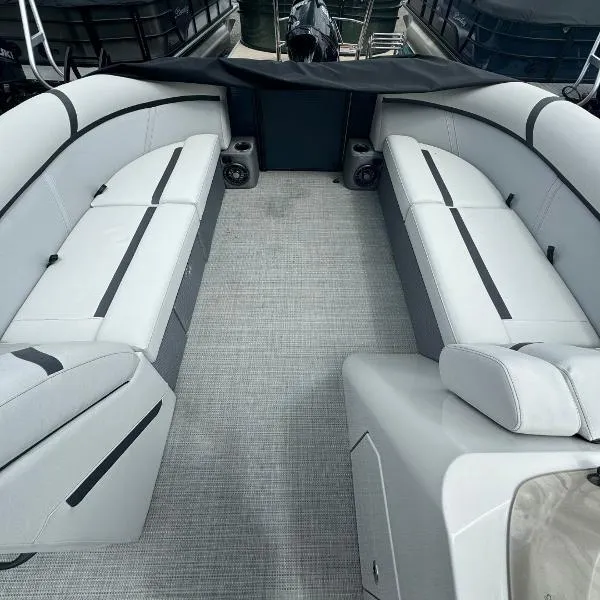 Slide: The Image of 2024 Crest Classic DLX 220 SLRC boat interior with gray seating and carpet flooring. - 3