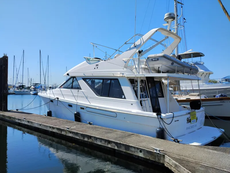 Slide: The Image of 1997 Bayliner 3988 Motor Yacht docked at marina under clear blue sky. - 1