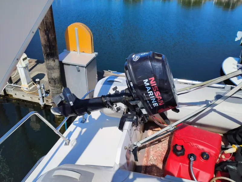 Slide: The Image of Outboard motor on 1997 Bayliner 3988 Motor Yacht, docked by calm water. - 10
