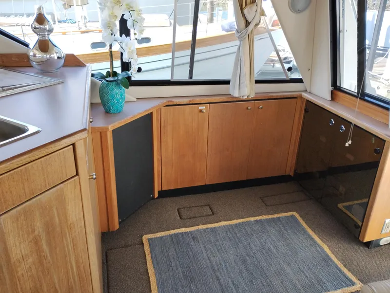 Slide: The Image of 1997 Bayliner 3988 Motor Yacht interior with wood cabinetry and large windows. - 15
