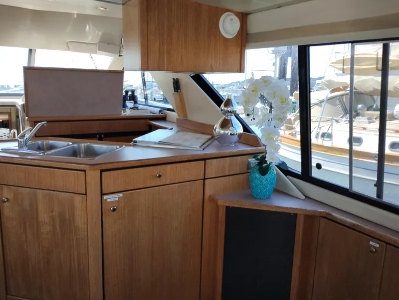 Slide: The Image of Interior of 1997 Bayliner 3988 Motor Yacht with wooden cabinetry and floral decor. - 17