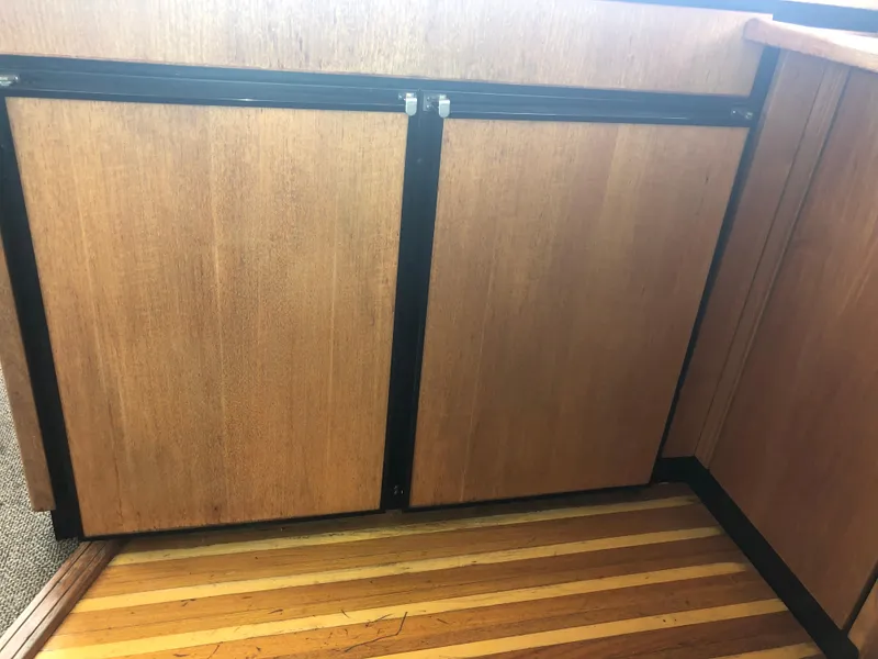 Slide: The Image of Wooden cabinetry and striped flooring inside a 1997 Bayliner 3988 Motor Yacht. - 21