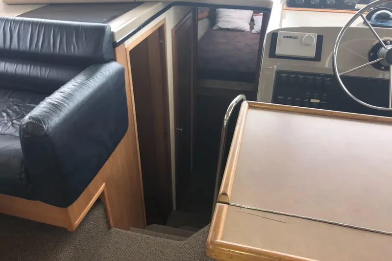 Slide: The Image of 1997 Bayliner 3988 Motor Yacht interior with steering wheel, seating, and cabin entrance. - 30