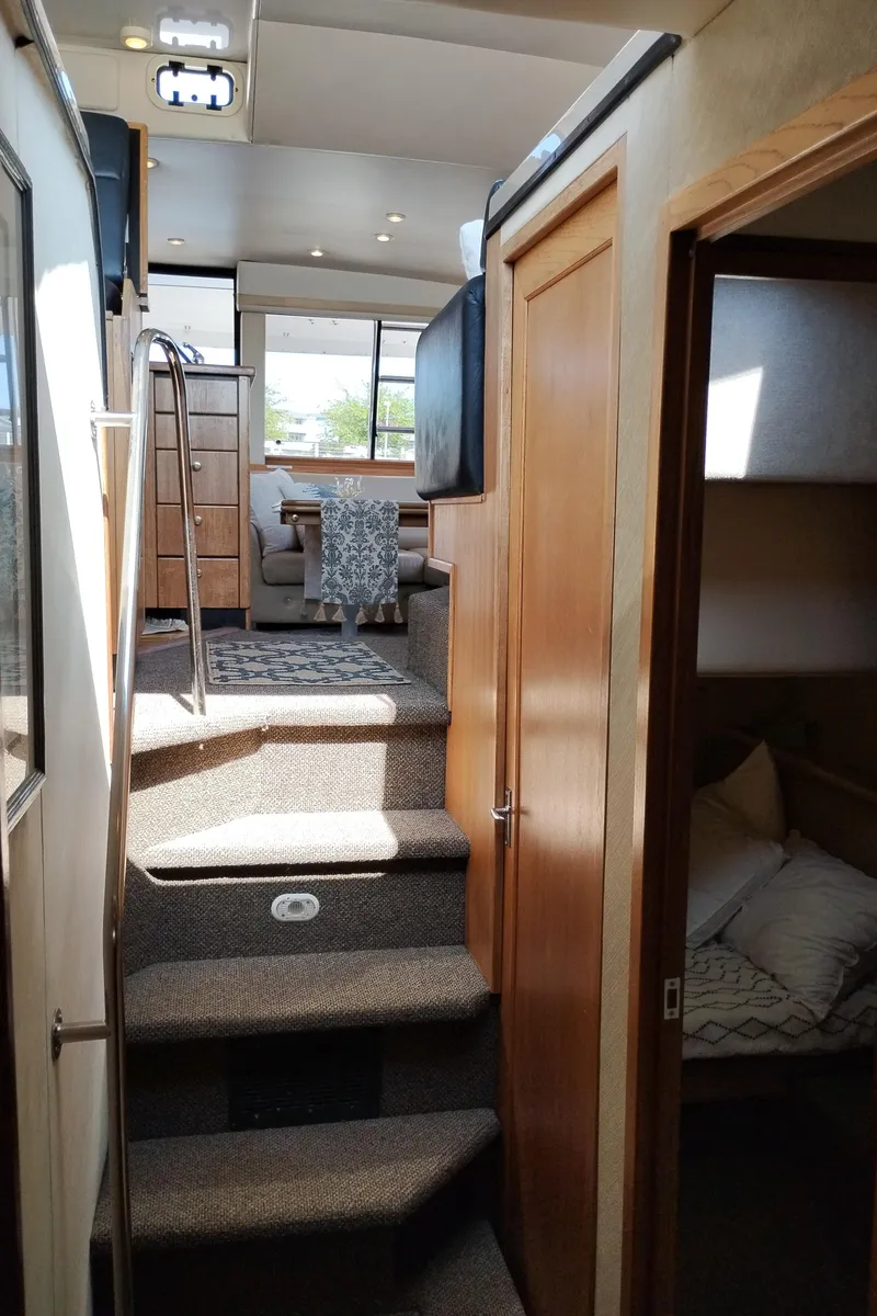 Slide: The Image of Interior view of 1997 Bayliner 3988 Motor Yacht with stairs and cozy cabin. - 37