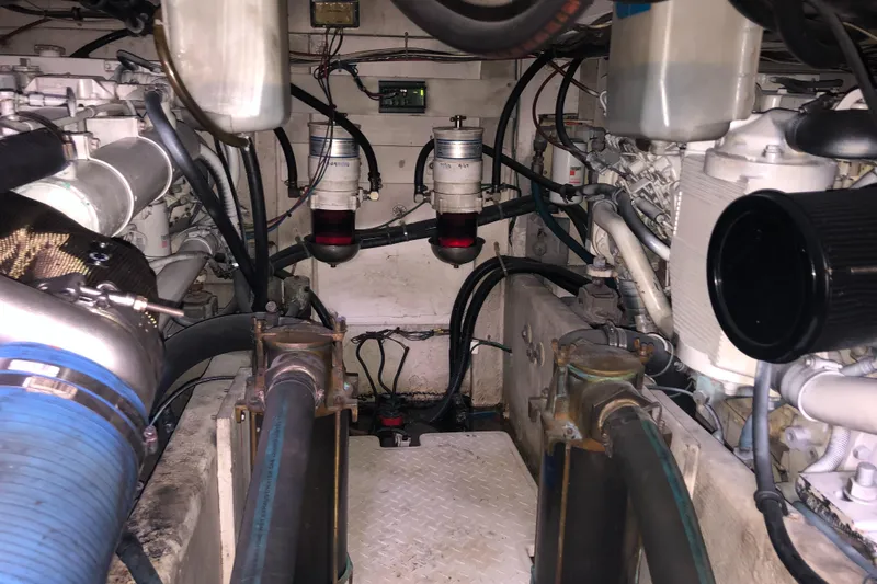 Slide: The Image of Engine room of 1997 Bayliner 3988 Motor Yacht, showcasing mechanical components and piping. - 41