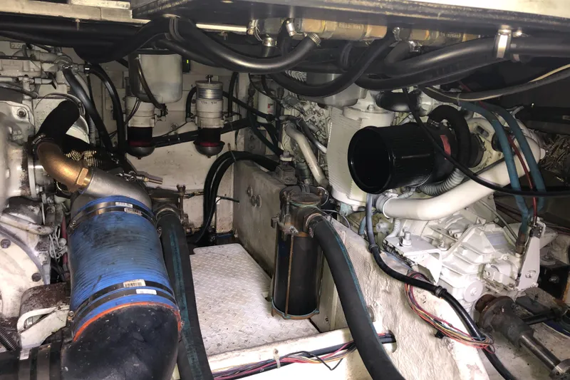 Slide: The Image of Engine room of a 1997 Bayliner 3988 Motor Yacht, showcasing mechanical components and hoses. - 44
