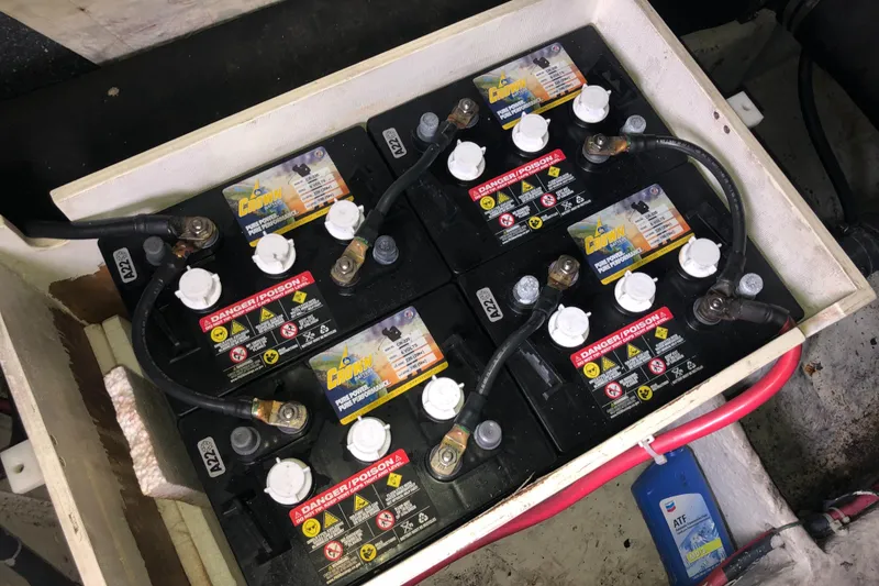 Slide: The Image of Battery compartment of a 1997 Bayliner 3988 Motor Yacht, featuring multiple connected batteries. - 45