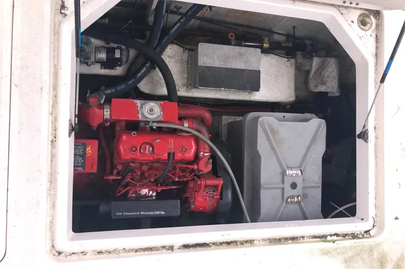 Slide: The Image of Engine compartment of a 1997 Bayliner 3988 Motor Yacht, featuring a red engine and storage tank. - 47