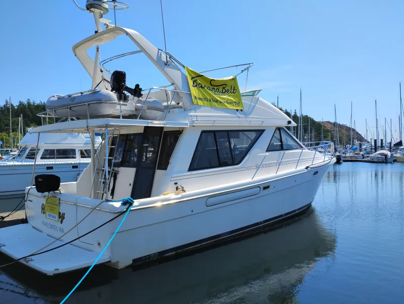 Slide: The Image of 1997 Bayliner 3988 Motor Yacht docked at marina, clear sky, calm water. - 48