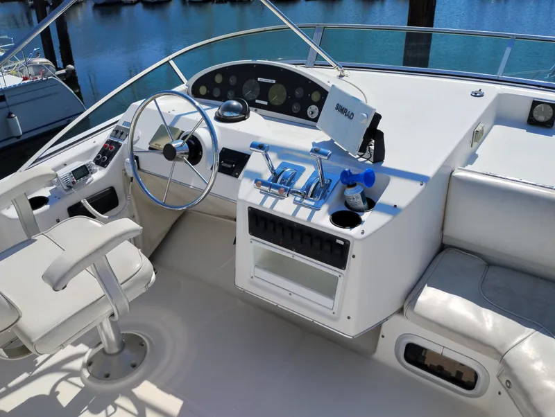 Slide: The Image of 1997 Bayliner 3988 Motor Yacht helm with steering wheel, controls, and seating. - 5