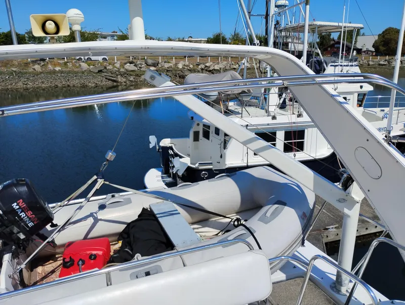Slide: The Image of Bayliner 3988 Motor Yacht 1997 with inflatable boat and outboard motor docked at marina. - 9
