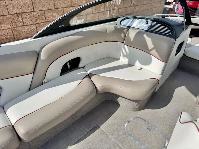 Slide: The Image of 2007 Malibu Wakesetter 247 LSV interior with beige seating and red accents. - 24