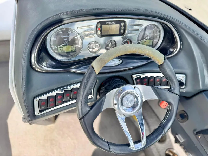 Slide: The Image of 2007 Malibu Wakesetter 247 LSV dashboard with steering wheel and control panel. - 32