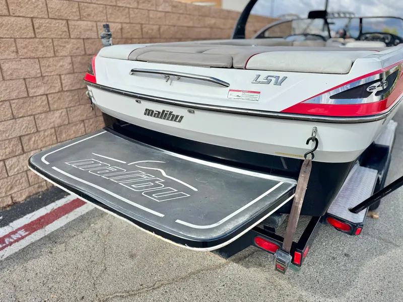 Slide: The Image of 2007 Malibu Wakesetter 247 LSV boat with swim platform, parked on concrete. - 6