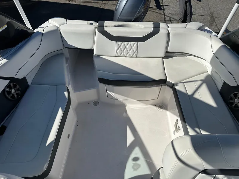 Slide: The Image of 2018 Regal 23 OBX boat interior with spacious white seating arrangement. - 11