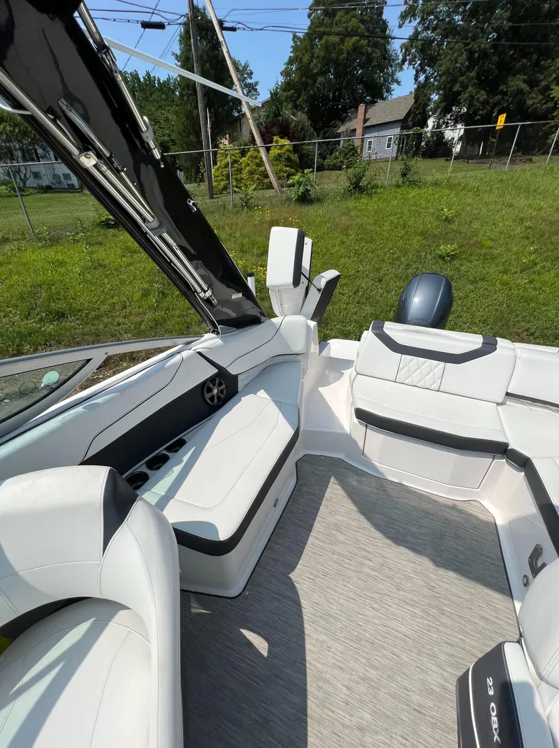 Slide: The Image of 2018 Regal 23 OBX boat interior with white seating and open deck layout. - 12