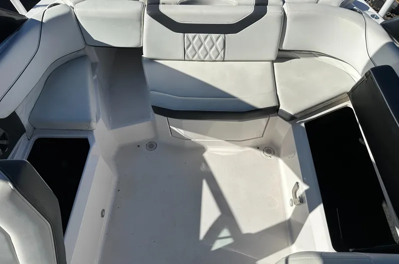 Slide: The Image of 2018 Regal 23 OBX boat interior with white and gray seating and storage compartments. - 14