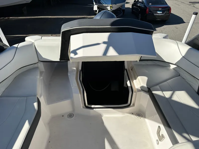 Slide: The Image of 2018 Regal 23 OBX boat interior with open storage compartment and seating area. - 15
