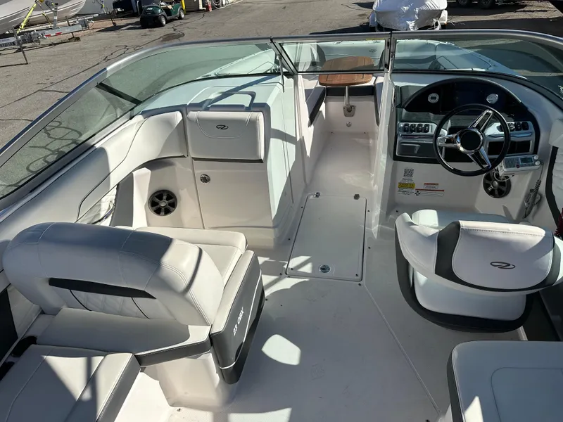 Slide: The Image of 2018 Regal 23 OBX boat interior with white seating and modern dashboard. - 17
