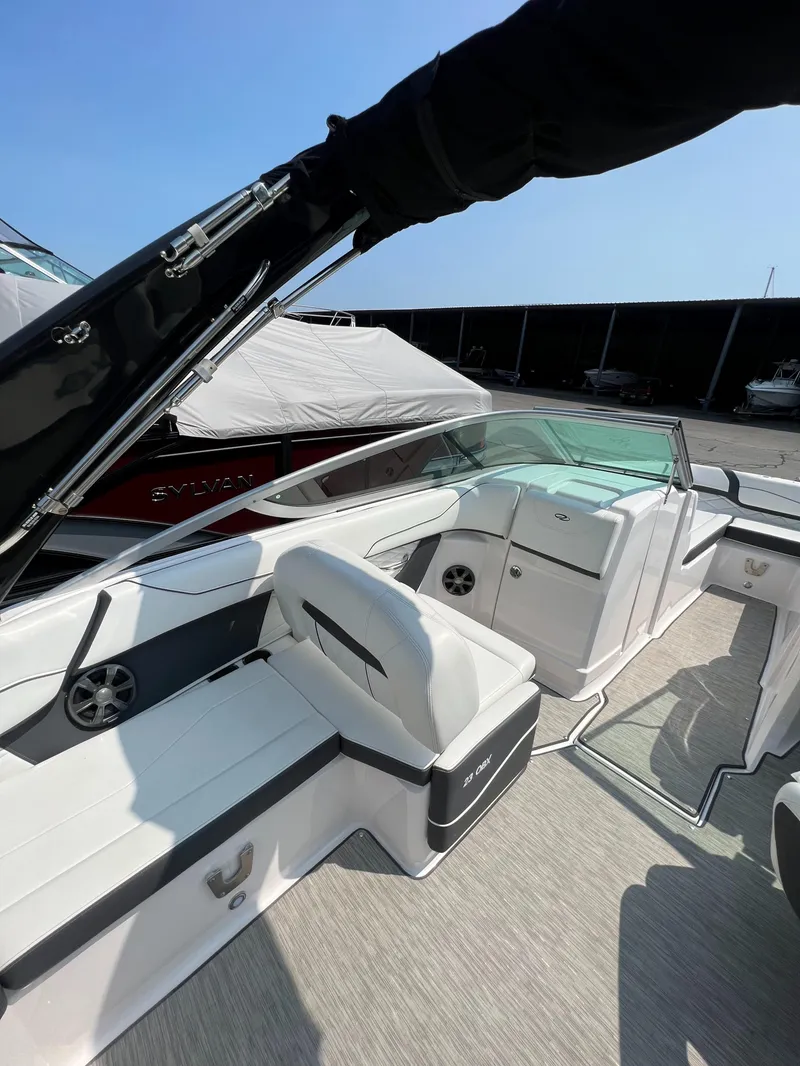 Slide: The Image of 2018 Regal 23 OBX boat interior with white seating and sleek design. - 19