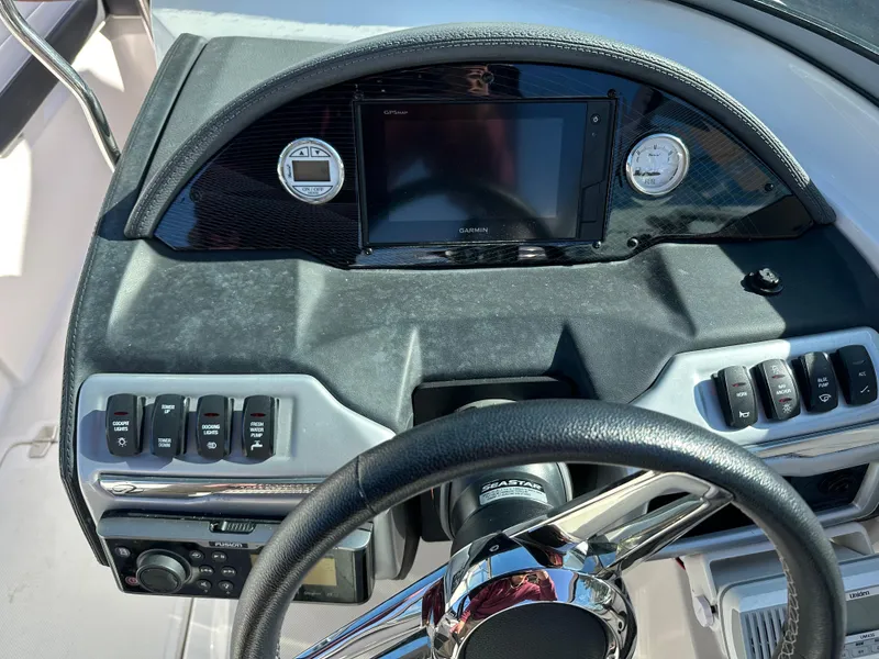 Slide: The Image of 2018 Regal 23 OBX boat dashboard with steering wheel and control panel. - 27