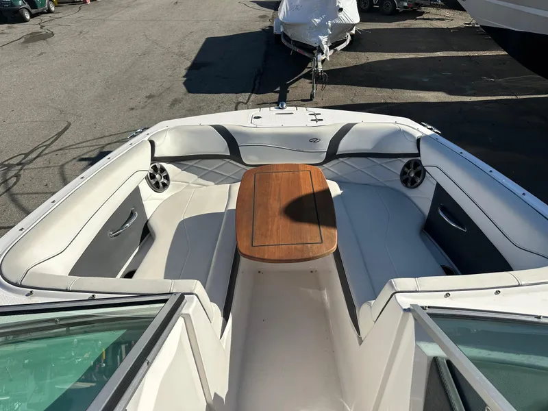 Slide: The Image of 2018 Regal 23 OBX boat interior with seating and wooden table. - 28