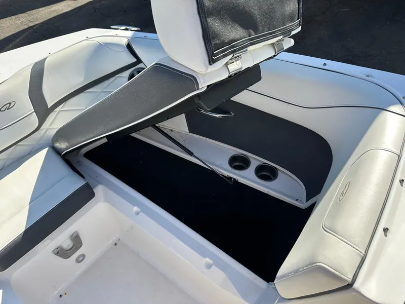 Slide: The Image of 2018 Regal 23 OBX boat interior with open storage compartment and cup holders. - 31