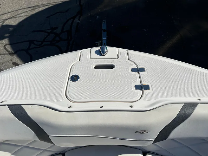 Slide: The Image of 2018 Regal 23 OBX boat bow with white upholstery and storage compartment. - 32
