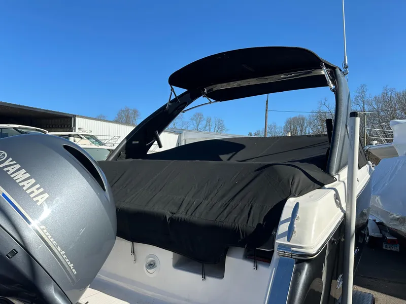 Slide: The Image of 2018 Regal 23 OBX boat with Yamaha outboard motor, covered and docked. - 36